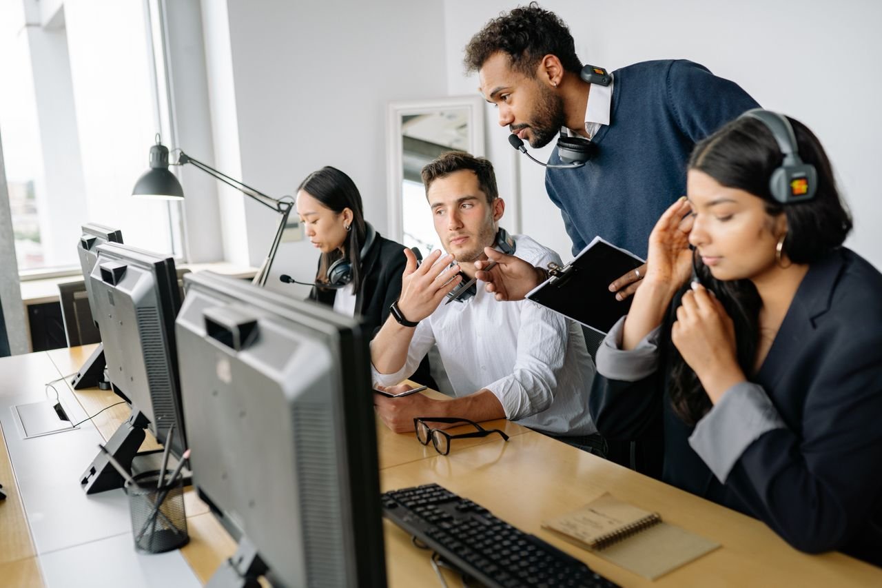 Our Services A diverse team of call center agents collaborating in a modern office environment.