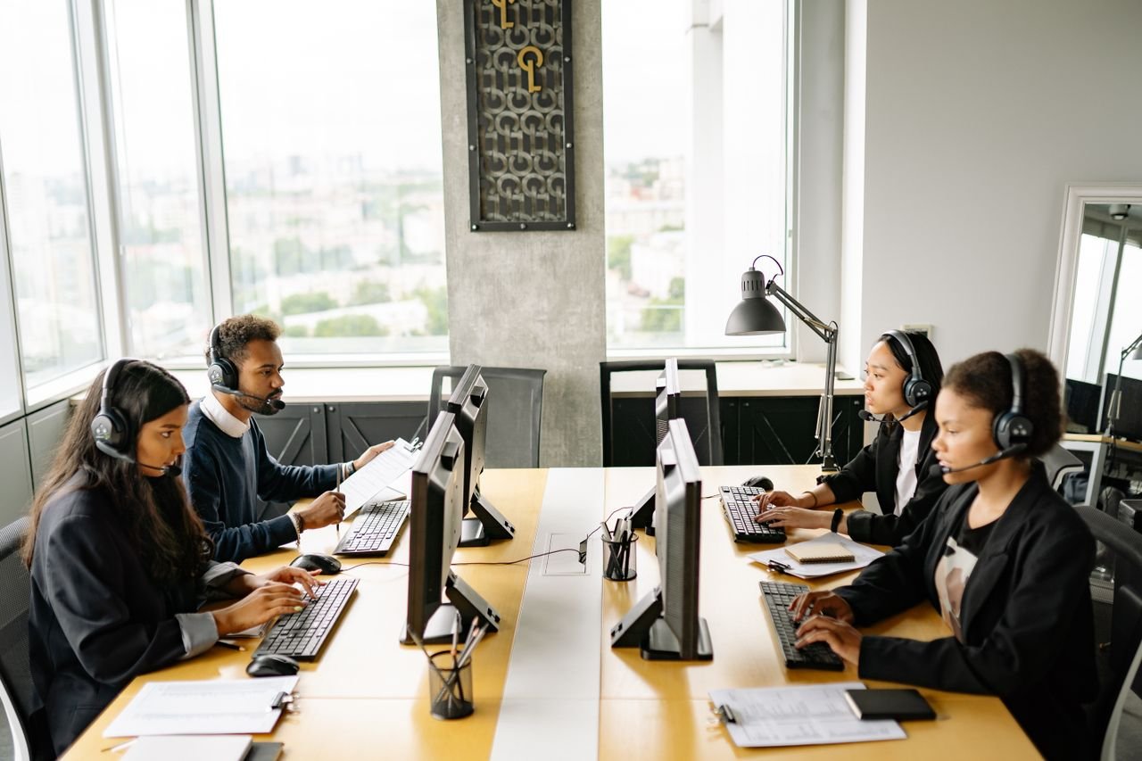 Our Services Group of diverse employees working together in a modern office setting, focusing on customer service.